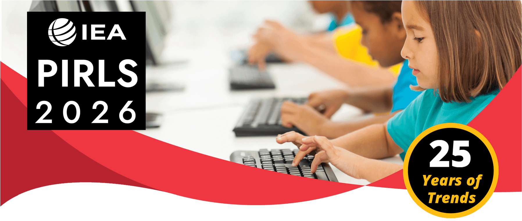 students sitting at a table typing on laptop keyboard.